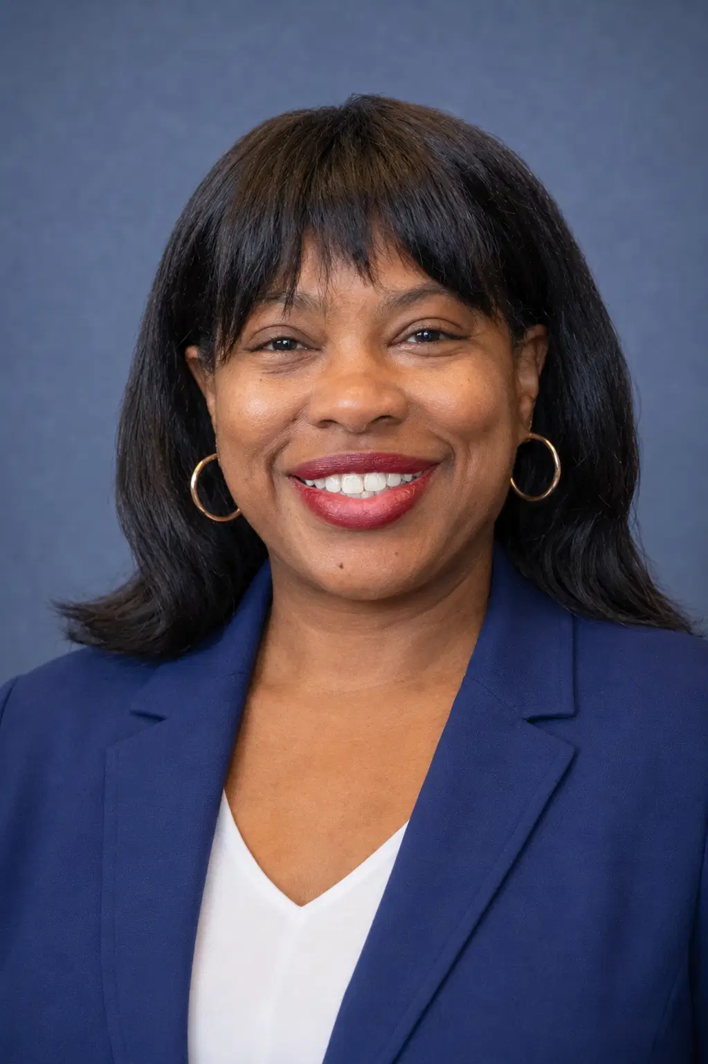 Erica Williams smiling in a navy blazer